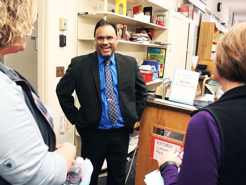 Rockne Roll/News-Register##Dayton superintendent candidate Jon Mishra chats with community members during an open house at Dayton Grade School on Thursday, March 16. He is one of two finalists who will be reinterviewed tonight.