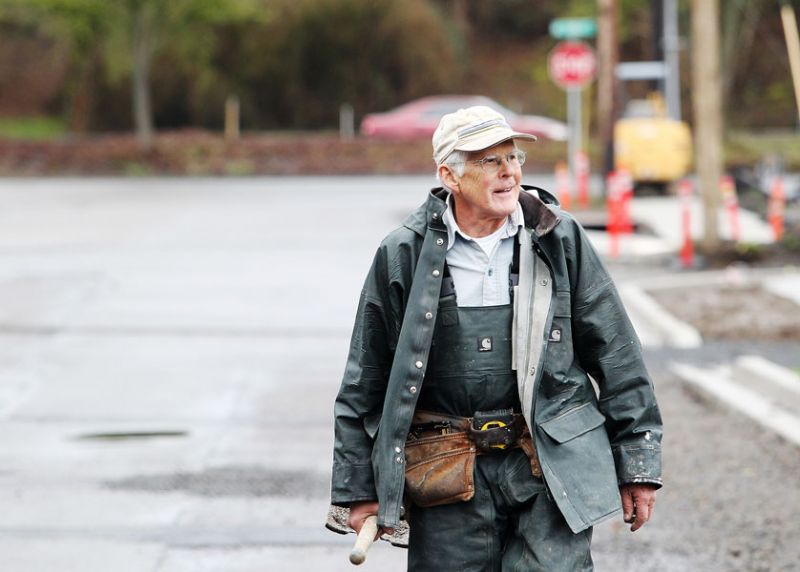 Rockne Roll/News-Register##Doug Cruikshank walks back after scooping a load of gravel at a Habitat for Humanity homesite in McMinnville. He usually volunteers Tuesdays, Thursdays and Saturdays.