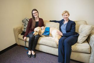 Rachel Thompson/News-Register##Sarah Grabner, Crime Victim Services Supervisor for the Yamhill County District Attorney’s Office, left, and Chief Deputy District Attorney Kate Lynch, spend some quiet time with the new courthouse dog, Nacho, the successor to retired Marybeth.