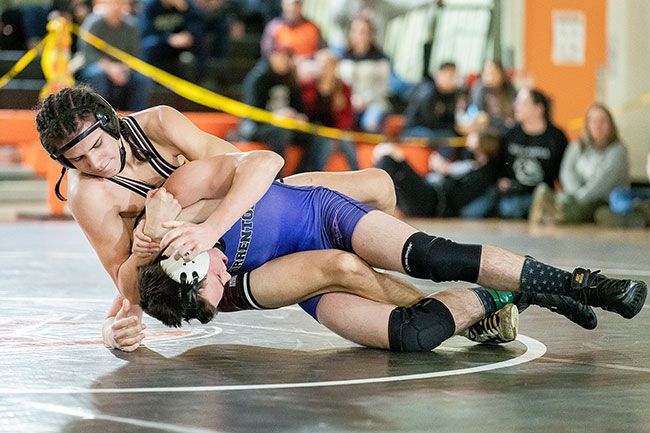 Dayton s Tony Cisneros prepares to pin a competitor at the district meet. He went on to a 28-0 season and second state title at the 145-pound weight class.