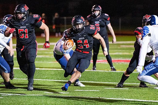 Marcus Larson/News-Register##
McMinnville tailback Preston Ginter breaks a 33-yard rushing touchdown during the second half of Friday s 26-14 win over Liberty.