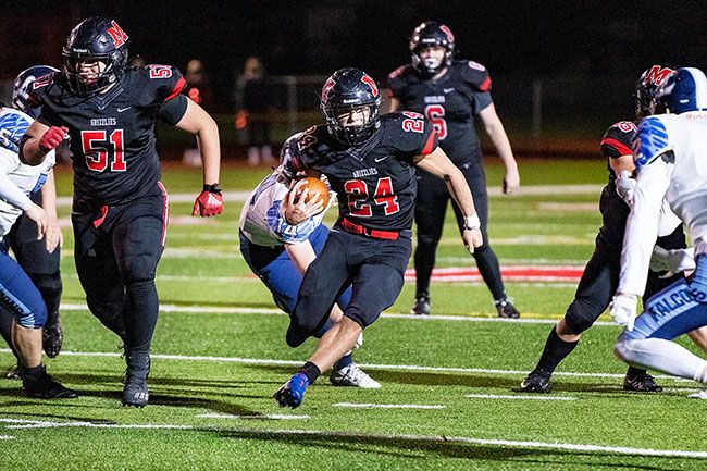 Marcus Larson/News-Register##
McMinnville tailback Preston Ginter breaks a 33-yard rushing touchdown during the second half of Friday s 26-14 win over Liberty.