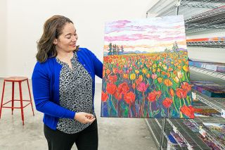 Marcus Larson/News-Register ## Landscape painter Erin Hanson shows off how her open impressionistic style captures blooms at the Woodburn Tulip Festival. Her brush strokes never overlap.