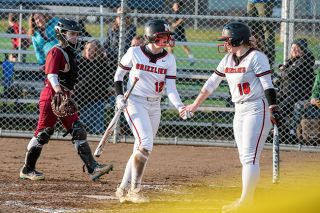 News-Register file photo##McMinnville s Libby Hardee (left) and Adi Paasch high-five after Hardee scores a run during a March game against Central Catholic. News-Register file photo##McMinnville s Libby Hardee (left) and Adi Paasch high-five after Hardee scores a run during a March game against Central Catholic.