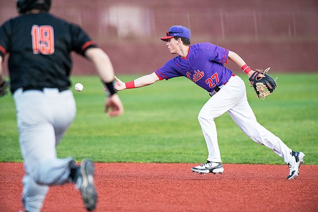 Rusty Rae/News-Register##
Linfield second baseman Mike LaVigne pitches the ball to the second baseman (not pictured) to start and inning-ending double play against Lewis & Clark.