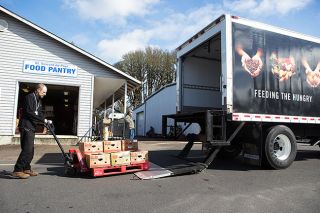 Rockne Roll/News-Register##
Dave Rucker off loads a delivery from Yamhill Community Action Partnership s new refrigerated food bank truck at St. Vincent de Paul in McMinnville Wednesday, March 28.