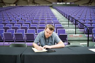 Rusty Rae/News-Register file photo##
The News-Register’s sports editor Logan Brandon takes notes during the McMinnville girls basketball team’s Class 6A state quarterfinal March 12 at the Chiles Center in Portland. The Grizzlies played their postseason contest in an empty arena, as the first wave of coronavirus-related cancellations rocked the sports world. Rusty Rae/News-Register file photo##
The News-Register’s sports editor Logan Brandon takes notes during the McMinnville girls basketball team’s Class 6A state quarterfinal March 12 at the Chiles Center in Portland. The Grizzlies played their postseason contest in an empty arena, as the first wave of coronavirus-related cancellations rocked the sports world.