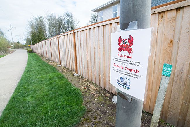 Marcus Larson / News-Register##Signs posted lalong the greenway trail in West McMinnville encourage youngsters to run in place, do jumping jacks and otherwise act like animals.