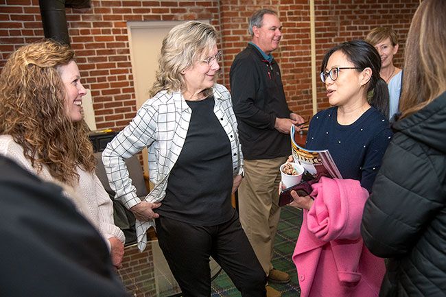 Rusty Rae/News-Register##MacHub founder Cami Nyquist, center, talks Monday with Xiaodi Zhang, right, an eBay director from New York, and at left, Patty Herzog, executive director of McMinnville Economic Development Partnership, during the online company’s visit to McMinnville, Zhang and others from eBay said they are impressed by what MacHub does for the community by reselling used items.