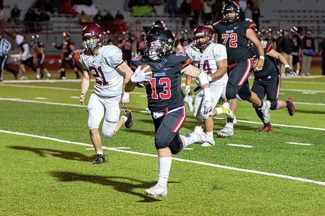 Marcus Larson/News-Register##
McMinnville running back Austin Rapp seals the Pigeon Bowl victory for the Grizzlies with a 43-yard touchdown rush in the fourth quarter. Mac beat Forest Grove, 30-0.