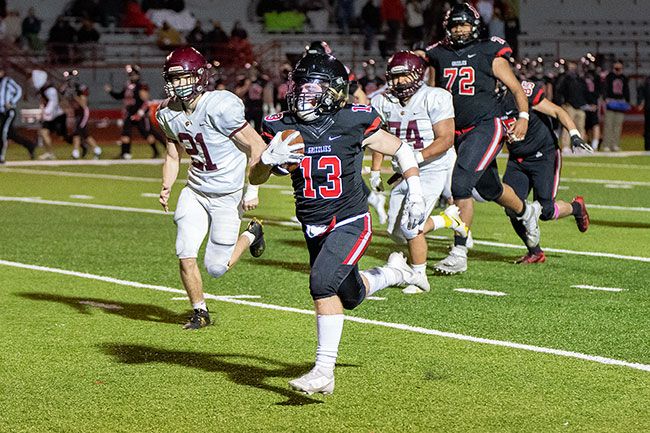 Marcus Larson/News-Register##
McMinnville running back Austin Rapp seals the Pigeon Bowl victory for the Grizzlies with a 43-yard touchdown rush in the fourth quarter. Mac beat Forest Grove, 30-0.