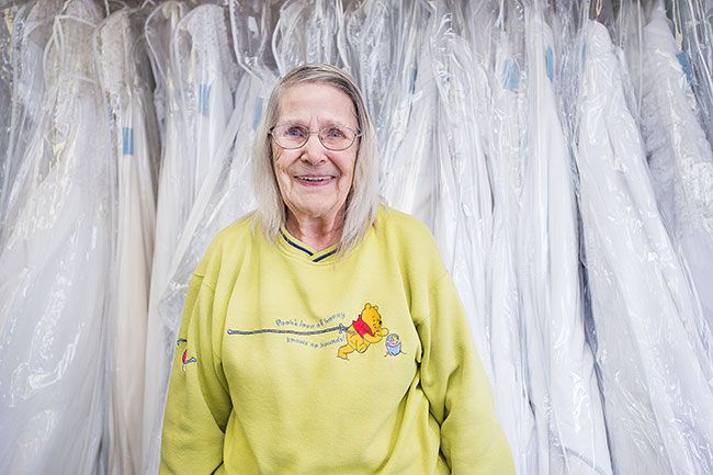 Marcus Larson/News-Register ##
Juanita Layton with some of the formal gowns she sells at Grandma’s Weddings. She’s been making wedding items for her shop for 38 years.