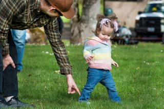 Marcus Larson/News-Register##
During Carlton s Easter Egg hunt, Jeremy Dewar points out an egg to his daughter Lilith Dewar-LaRoche. The 18-month-old ignored and picked up three other eggs, dropping two of them during her search.