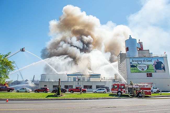 Rusty Rae/News-Register##Shortly after the Organic Valley Creamery fire started, a quarter-mile radius around the plant was evacuated and a wider shelter-in-place zone established. Firefighters, working from the ground and overhead, earned the praise of company officials for their efforts battling the April blaze.