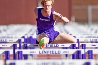 Rusty Rae/News-Register##
Linfield’s Keaton Wood races through the men’s 110m hurdles during his preparation for the decathlon.