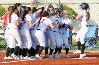 Rockne Roll/News-Register ##
A crowd of Dayton players welcomes Sierra Ray to home plate following her walk-off grand slam in Monday’s 7-3 defeat of the Banks Braves in Dayton.