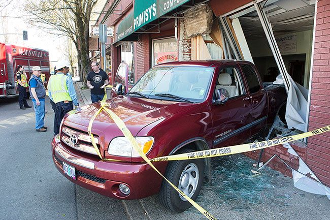 Rockne Roll/News-Register##
Crews from McMinnville Water & Light and the McMinnville Fire Department respond to the Primisys building on Northeast Baker Street in McMinnville Sunday, April 22, after a truck crashed through the front of the building.