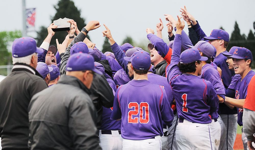 Rusty Rae/News-Register##
Linfield’s baseball team celebrates its Northwest Conference title run after the trophy presentation Sunday. The ‘Cats had to come through the consolation round by winning four straight games after a first round loss.