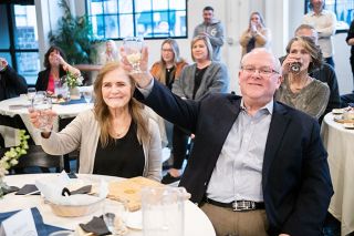 Marcus Larson/News-Register##Outgoing Mayor Scott Hill and his wife, Donna, raise their glasses during a toast at the MDA awards ceremony. Hill was honored with the revived Wally Wright Award at the event.
