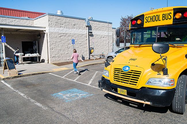 Marcus Larson/News-Register ##
A bus pulls up to the Dayton High School cafeteria to collect grab-and-go lunches for distribution to students of all ages. Food service director Pam Johnson said meal service is different these days, but children are still receiving good, filling food.