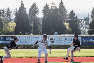 Rusty Rae/News-Register##With runners on the corners, Mitchell Taylor broke from first base and danced around a Newberg run-down, until the runner on third base scored padding the Grizzlies lead late in the game Monday at Patton field. Rusty Rae/News-Register##With runners on the corners, Mitchell Taylor broke from first base and danced around a Newberg run-down, until the runner on third base scored padding the Grizzlies lead late in the game Monday at Patton field.