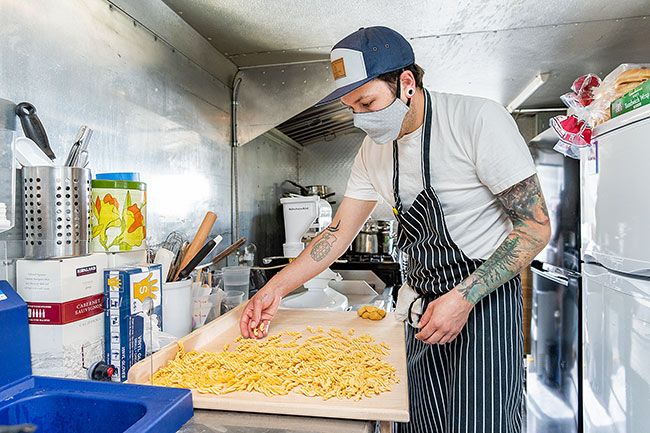 Marcus Larson/News-RegisterMother Sauce food truck owner Andrew Jensen prepares fresh fusilli pasta shortly after opening for the day. The food truck is located on Davis Street between First and Second. The Mac High grad said he and his partner, Allie Bisset, are happy to be serving people in his hometown.