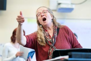 Marcus Larson/News-Register ## Retiring teacher Robin Pederson sings along with her class, demonstrating how the different parts should sound. She said her final year at McMinnville High School has been a good one — especially since students have been able to return to rehearsals indoors.