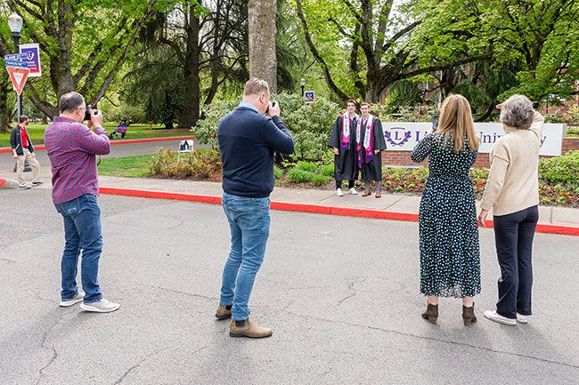 Marcus Larson/News-Register ##
Linfield graduates and friends Luke Marks and Chase Whittaker pose for a portrait together in front of the Linfield University sign.