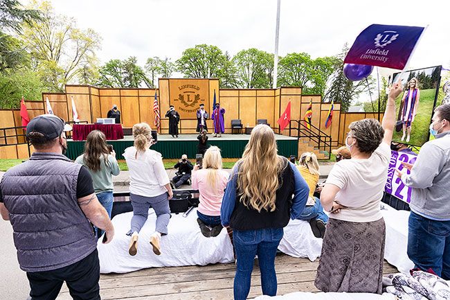 Marcus Larson/News-Register  ##
The family of Shakayla Snyder cheers from a graduation themed float as she officially receives her diploma on Sunday.