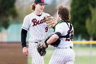 Marcus Larson/News-Register##
McMinnville catcher Parker Guinn congratulates his pitcher Ky Hoskinson after he tossed a one-hitter during Tuesday’s 9-0 win over Forest Grove.