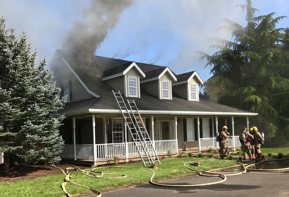 Tualatin Valley Fire & Rescue photo##Smoke pours from the rural Newberg home Monday afternoon.
