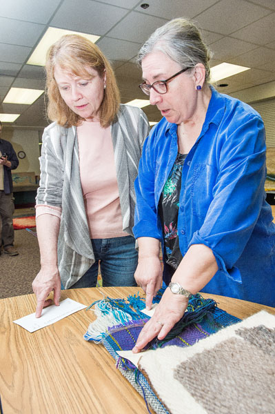 Rusty Rae/News-Register ## Marta and Katia Johansen examine some of the small studies their mother wove prior to starting on larger versions of tapestries.