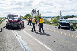 Marcus Larson/News-Register##Oregon State troopers and McMinnville officers investigate a head-on crash this past Thursday on Highway 18 near the Booth Bend overpass.