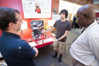 Marcus Larson/News-Register##Linfield student inventor Joe Mantano shows his Smart mirror invention to attendees at the Linfield College Student Symposium.