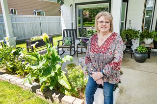 Marcus Larson/News-Register ##
Cheryl Wilkinson and her husband added a roof over their front porch and planted calla lilies, among many other foliage and flowering plants, helping them win the May Yard of the Month honor.
