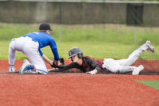 Rusty Rae/News-Register##
Dayton leadoff hitter Benji Hudson attempts to steal second base during Wednesday’s league matchup against Blanchet Catholic. Hudson was called out on the play, despite a great attempt to avoid the tag.