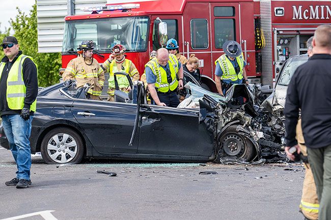 Marcus Larson/News-Register##Oregon State Police and rescue personnel work the scene of a fatal two-vehicle crash Tuesday afternoon in the area of the Amity-Dayton Highway and Stringtown Road. A Salem woman was killed, according to the Oregon State Police.