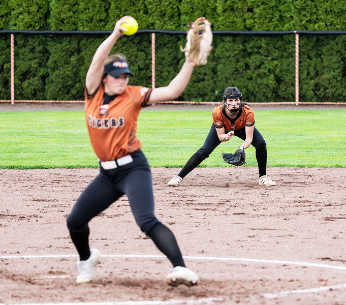 Marcus Larson/News-Register##
As Yamhill-Carlton starting pitcher Kati Slater delivers a strike, second baseman Lexiss Antle prepares to receive any ground ball which comes in her direction. The pair led the Tigers to Tuesday’s 14-0 win over Amity.