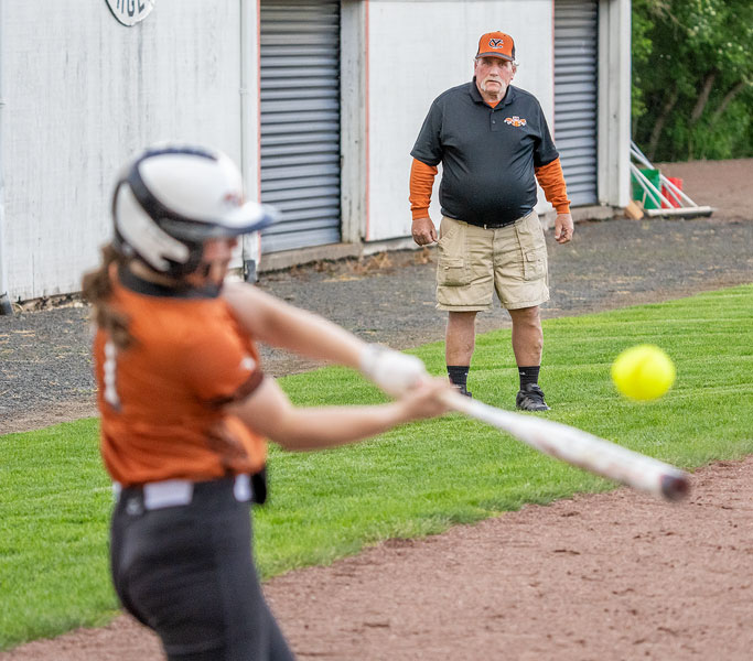 Marcus Larson/News-Register##
Yamhill-Carlton head coach John Kuehnel watches from the third base box as Kaitlyn Knapp takes a cut at a pitch high in the zone during Tuesday’s matchup