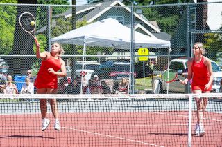 Rusty Rae/News-Register##
Mariah Arnold (left) smashes an overhead shot during Saturday’s Pacific Conference Tournament girls tennis semifinals. Arnold, along with her teammate, Ainslie Ridgway (right), won the doubles championship to complete an undefeated season.