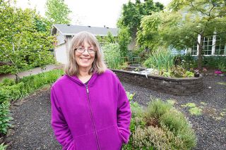 Marcus Larson/News-Register##Lynn Crowell’s charming mixture of herbs,
vegetables, flowers and fruiting shrubs made her yard a winner with the McMinnville Garden Club. She designed her McMinnville property to be beautiful, productive, edible and easy to maintain, with raised beds set in gravel paths.