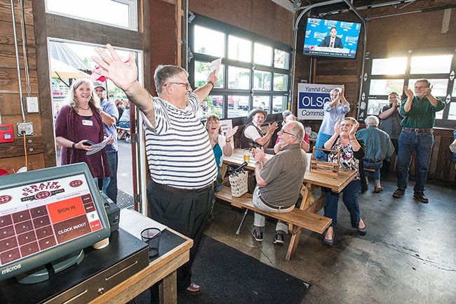 Marcus Larson/News-Register##After returning from the Clerks Office, Mayor Rick Olson receives applause from the crowd gathered at the Grain Station, for his 2,459 vote lead in the Yamhill County Commissioners race over incumbent Allen Springer.