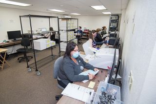Marcus Larson/News-Register##A team of volunteers go through the slow process of adjudicating write-ins on turned in ballots. Marcus Larson/News-Register##A team of volunteers go through the slow process of adjudicating write-ins on turned in ballots.