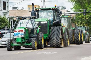 Marcus Larson/News-Register##Several farmers drove their tractors down Fifth Street in front of the Yamhill County Courthouse in protest of the proposed Yamhelas Westsider Trail.