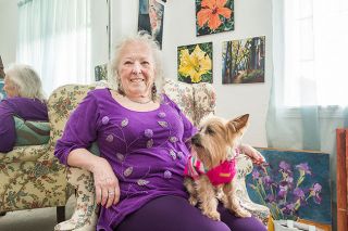 Marcus Larson/News-Register##Benita Cole and Xena enjoy living in McMinnville, where a sunny bedroom serves as the artist’s studio.