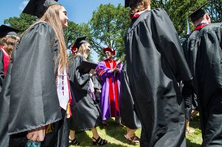 Marcus Larson/News-Register##
Lined up on either side, Linfield College President Miles K. Davis and
professors cheer on the graduates as they pass through a  gauntlet of
one last inspection  before being official graduates of the college.