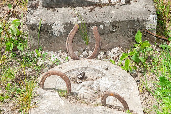 Rusty Rae/News-Register ## Several headstones at the Malone Cemetery are decorated with horseshoes — here, one is pushed into the dirt between sections of broken stone.