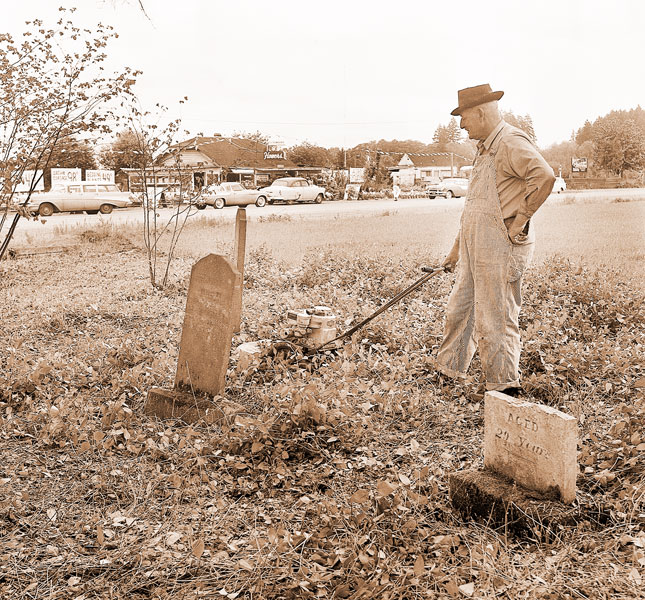 ## James Robb of Lafayette clears brush at Malone Cemetery in this May 16, 1961, News-Register photo. The property has been cared for by various individuals and groups over its 170-year history but has fallen into disrepair in the past decade.