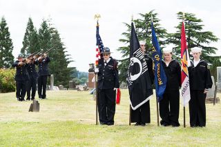 Marcus Larson / News-Register##
As a color guard holds the U.S., Oregon, POW/MIA and honor flags, members of the county honor guard fire three rounds of three in honor of those who ve given their lives in service to the country.