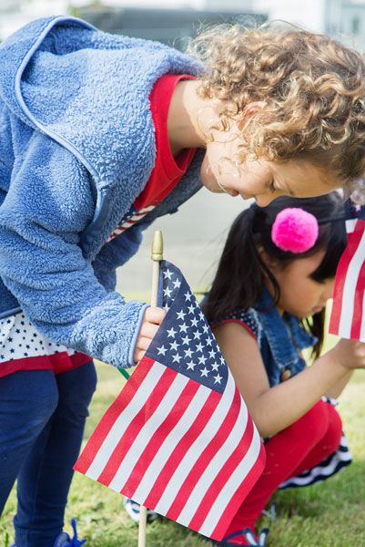 Rockne Roll/News-Register##
Five-year-old Rachel Wilkins, front, and 4-year-old Alyssa Fernandez plant their flags as McMinnville Christian Academy students set up their Memorial Day flag display Friday, May 25.